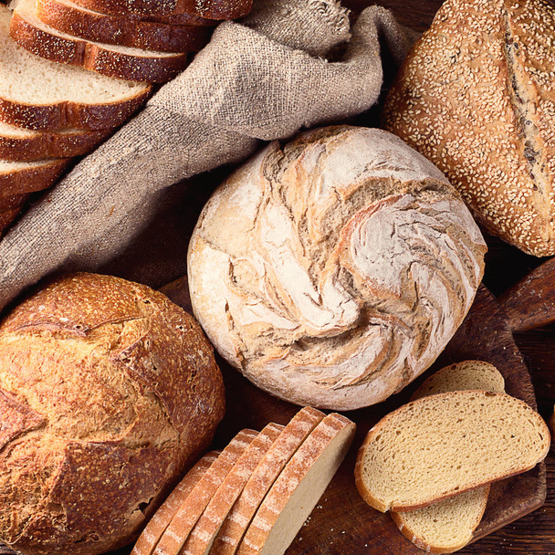 Mixed bread on white wooden table background. Top view  - Photo, image
