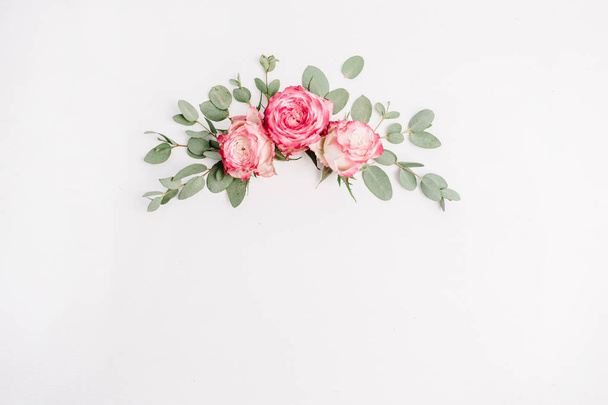 Floral composition with pink rose flower buds and eucalyptus. Flat lay, top view background. - Photo, Image