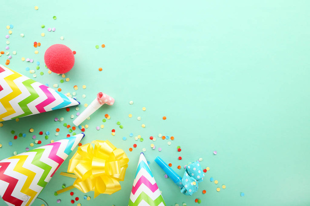 Birthday party caps, blowers and confetti on mint background - Фото, изображение