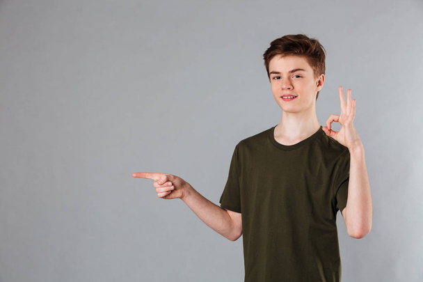 Portrait of a confident male teenager wearing t-shirt - Zdjęcie, obraz