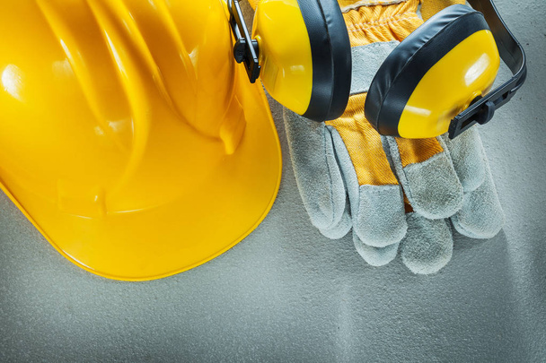 Earmuffs protective gloves building helmet on concrete backgroun - Foto, Imagen