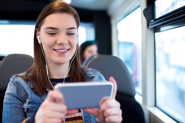 Woman Watching Movie On Mobile Phone During Journey To Work - Photo, Image
