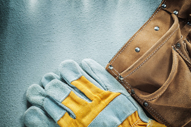 Leather tool belt protective gloves on concrete background - Foto, imagen
