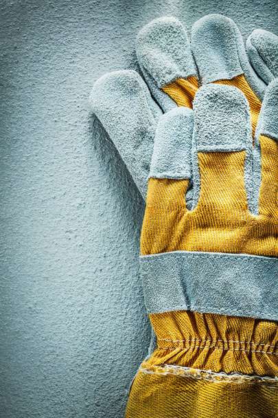Pair of protective gloves on concrete background top view - Foto, afbeelding