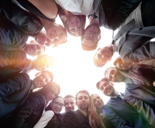 large business team is forming a circle and looking at the camer - Photo, image
