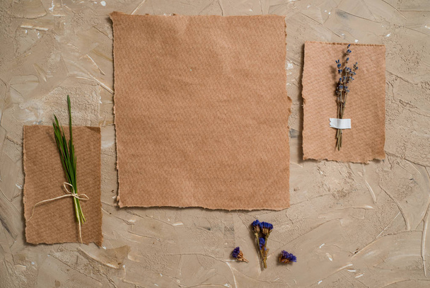 Notepad is a notebook for entries. Kraft paper postcard. Herbarium of dry grass of lavender flowers. On a brown antique background - Fotografie, Obrázek