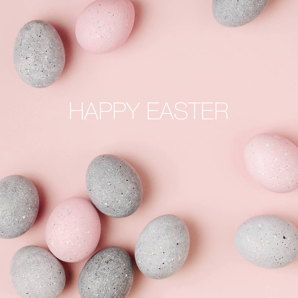 Stylish Frame of pale pink and gray Easter eggs with copy space for text.  Flat lay  - Φωτογραφία, εικόνα
