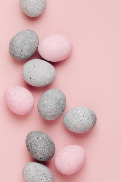 Group pale pink and gray Easter eggs on pastel  background. Flat lay  - Foto, Bild