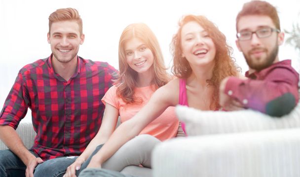 group of cheerful friends sitting on sofa - Photo, Image
