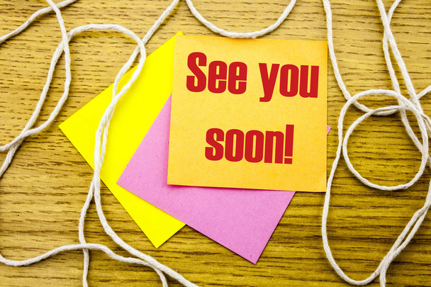 See you soon - word on yellow sticky note in wooden background. Bussines concept. - Photo, Image