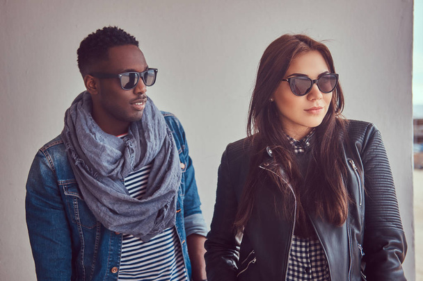 Portrait of an attractive stylish couple. An African-American man and Caucasian girl. - Fotoğraf, Görsel