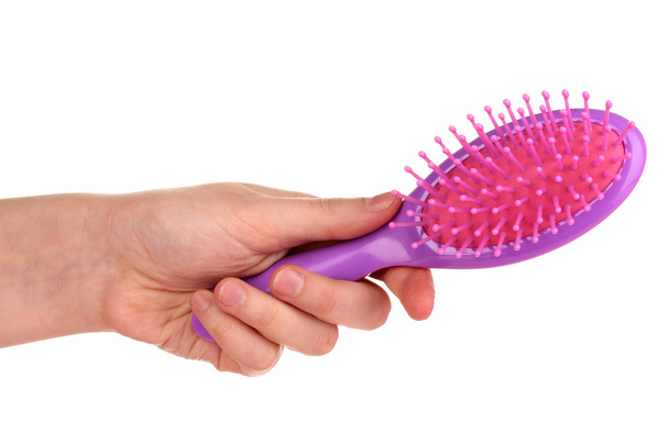 purple hair brush in the hand isolated on white - Фото, изображение
