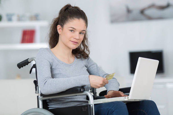 Young disabled girl using laptop - Fotó, kép