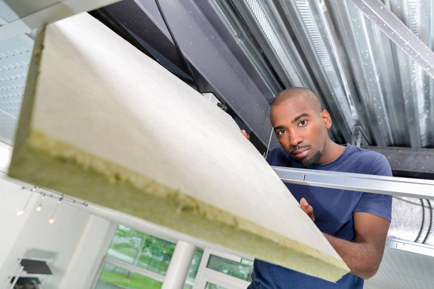 Man fitting roof insulation - Photo, Image