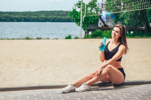 Pretty young sporty girl relaxing after outdoor training - Zdjęcie, obraz