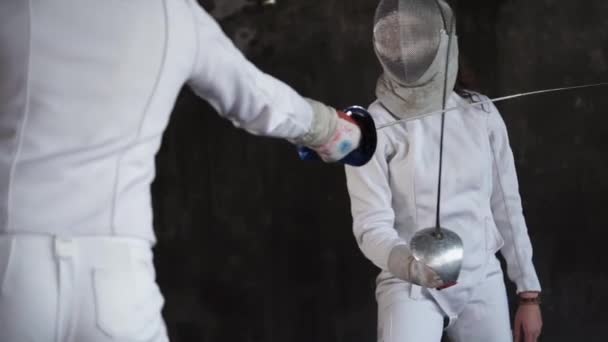 Training of two young fencers in a sports school, close up of head and foils - Footage, Video