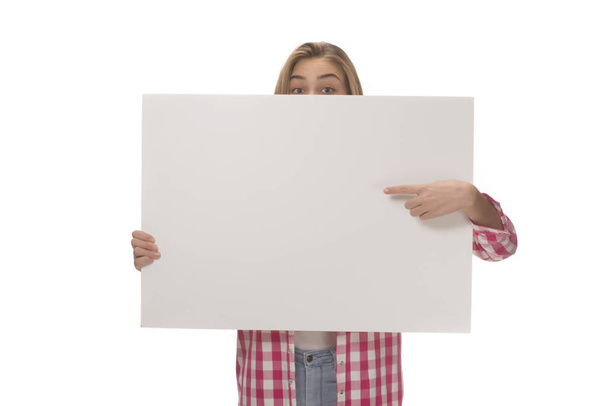 Young woman holding empty white board card. isolated on white - Valokuva, kuva