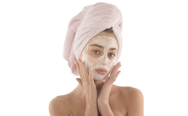 Beauty procedures skin care concept. Young woman applying facial mud clay mask to her face - Photo, Image