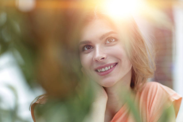 portrait of smiling woman face on blurred background. - Fotografie, Obrázek