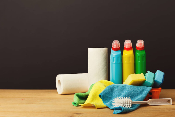 Colorful group of cleaning supplies on dark background - Photo, Image