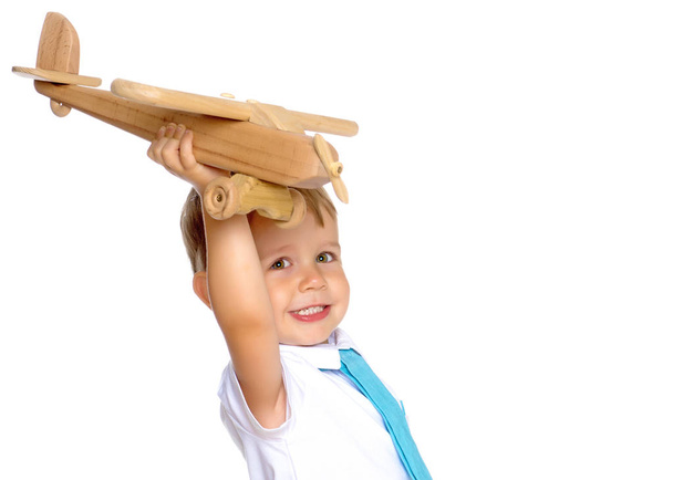 Little boy playing with wooden plane - Fotoğraf, Görsel