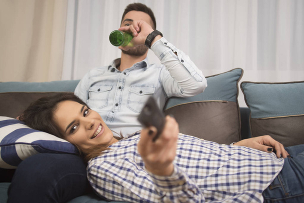 Beautiful couple watching TV at home - Zdjęcie, obraz