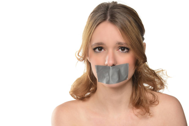 una joven con cinta adhesiva en la boca. aislado en blanco
 - Foto, Imagen