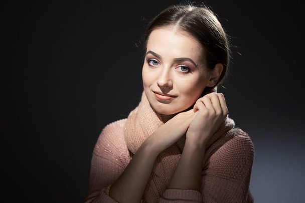 beautiful girl in pink knitted sweater. emotional portrait on a dark background. - Photo, Image