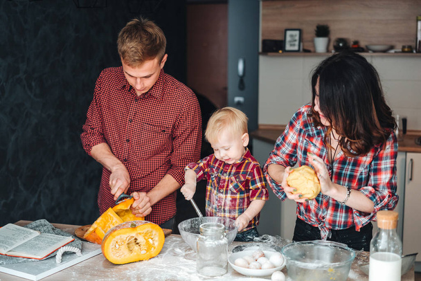 Papa, maman et petit fils cuisinent une tarte
 - Photo, image