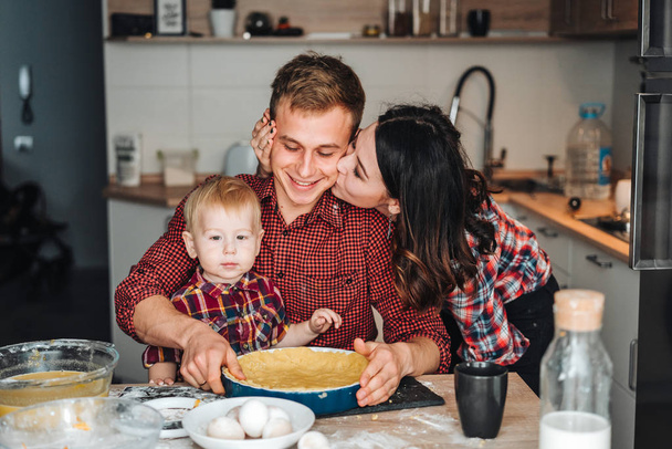 Dad, mom and little son cook a pie - Photo, Image
