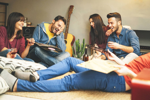 Onnellisia nuoria ystäviä hauskaa kotona kuunnellen vintage vinyyli levy musiikkia olohuoneessa - Ryhmä ihmisiä nauttivat aikaa asunnossa juominen laukausta ja nauraa
 - Valokuva, kuva