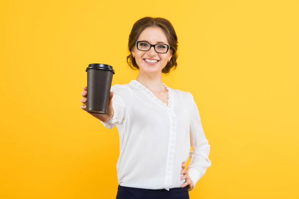 Young brunette woman holding paper cup  - Fotó, kép