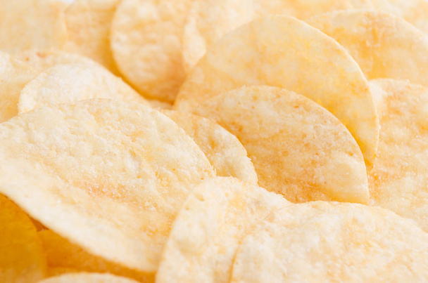 Crunchy potato chips with spices as background, closeup. - Photo, Image