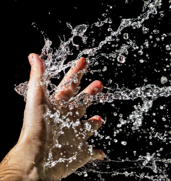 Hand and splashing water - 写真・画像