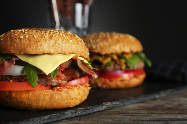 Tasty burger on slate plate, closeup - Фото, изображение