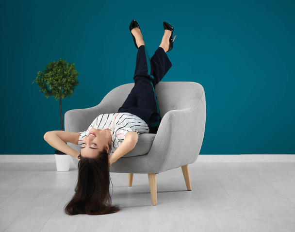 young woman in comfortable armchair - Foto, Bild