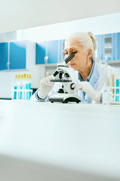 Laboratory Research. Woman Looking Through Microscope. - Foto, Imagen