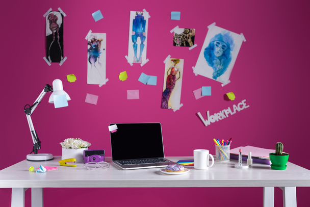 fashion designer workplace with sketches and laptop on table - Foto, Imagen