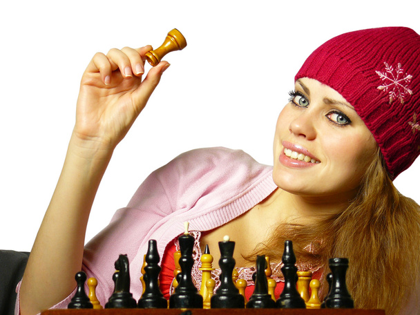 Chica juega al ajedrez sobre un fondo blanco
 - Foto, Imagen