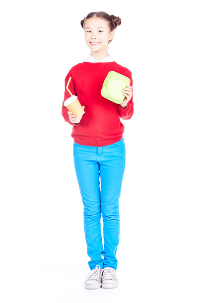 Schoolgirl holding lunchbox - Fotoğraf, Görsel