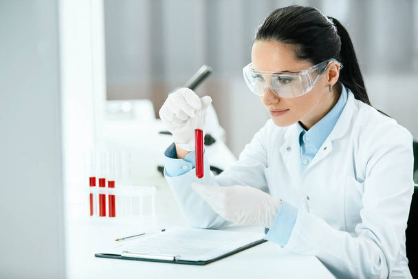 Laboratory. Woman Doing Medical Research With Blood. - Zdjęcie, obraz