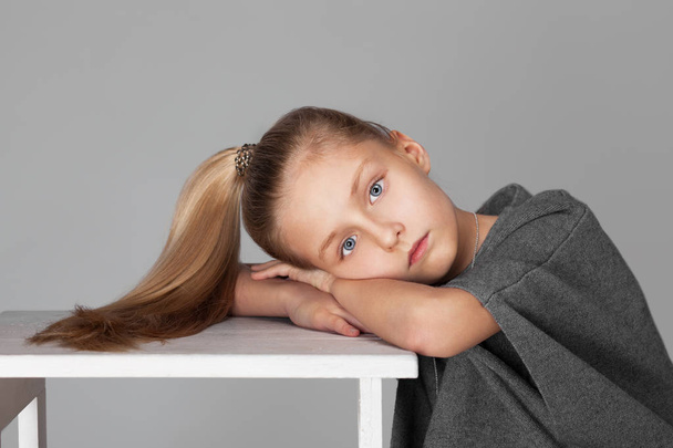 Portrait of a cute girl with long hair in the photostudio - Photo, image