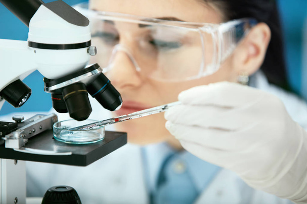 Medical Analysis. Female Scientist Doing Test In Laboratory - Фото, зображення