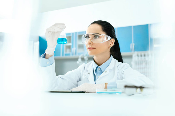 Scientific Laboratory. Female Scientist With Laboratory Glass. - Foto, afbeelding