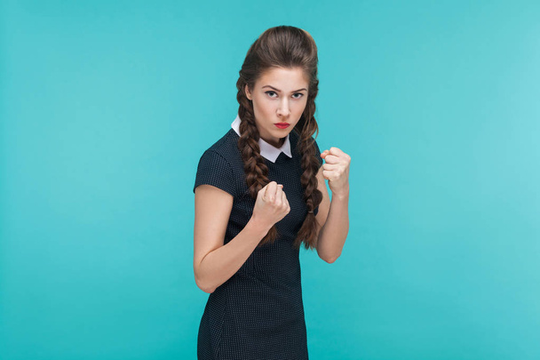 aggressive businesswoman posing in combat pose on blue background, boxing concept - Zdjęcie, obraz