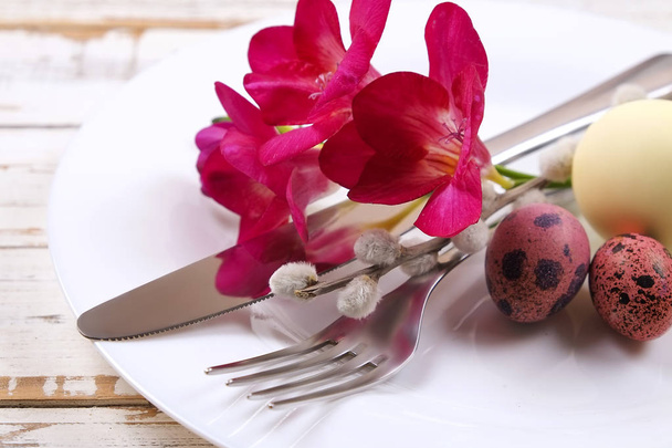 Easter laying table appointments, table setting options. Silverware, tableware items with festive decoration. Fork, knife and flowers. Happy easter holiday. - Фото, зображення