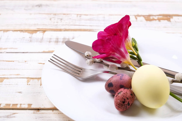 Easter laying table appointments, table setting options. Silverware, tableware items with festive decoration. Fork, knife and flowers. Happy easter holiday. - Photo, Image