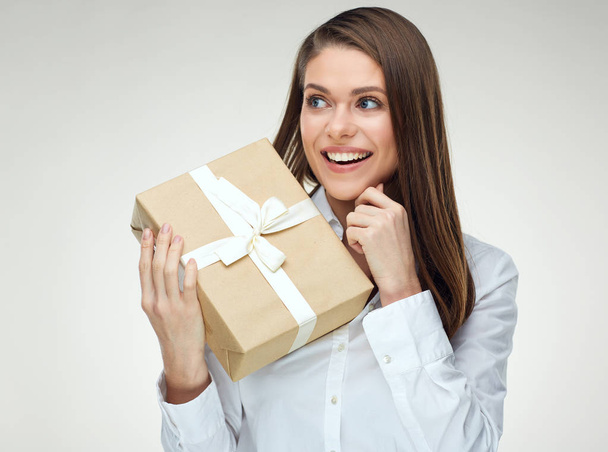 Business woman holding big gift box looking at side. - Фото, зображення