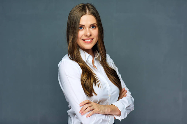 beautiful businesswoman standing with crossed arms on grey background, close-up  - Zdjęcie, obraz