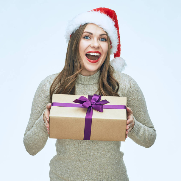beautiful surprised woman in Christmas hat holding gift box  - Foto, Imagen